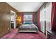 Cozy bedroom with wood paneled walls, large windows, and a comfortable bed at 75 Vrain St, Denver, CO 80219