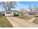 Quaint single story home featuring a well maintained front lawn and large driveway at 75 Vrain St, Denver, CO 80219