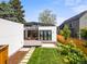 Modern home featuring a backyard with a deck, manicured lawn, stone path, and new fence at 2025 Fenton St, Edgewater, CO 80214