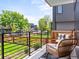 Inviting balcony featuring comfortable seating and offering a pleasant view of the surrounding neighborhood and lush greenery at 2025 Fenton St, Edgewater, CO 80214