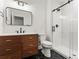 Bathroom featuring a vanity with a wood cabinet, a modern sink and mirror, and a glass enclosed shower at 2025 Fenton St, Edgewater, CO 80214