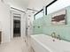 Modern bathroom featuring a soaking tub, glass-enclosed shower, and stylish tile accents at 2025 Fenton St, Edgewater, CO 80214