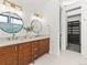 Elegant bathroom featuring dual sinks, modern fixtures, and a view into the walk-in closet at 2025 Fenton St, Edgewater, CO 80214