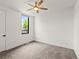 Bright bedroom featuring a ceiling fan, neutral carpet, and a window offering plenty of natural light at 2025 Fenton St, Edgewater, CO 80214