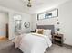 Well-lit bedroom with a comfortable bed, modern decor, and a glimpse into the luxurious bathroom at 2025 Fenton St, Edgewater, CO 80214