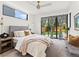 Bright bedroom featuring a plush bed, stylish curtains, and sliding glass doors to a private outdoor space at 2025 Fenton St, Edgewater, CO 80214