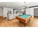 Stylish game room with a billiard table, a snack and beverage area, and modern staircase at 2025 Fenton St, Edgewater, CO 80214