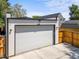 Modern two car garage with a white door and driveway at 2025 Fenton St, Edgewater, CO 80214