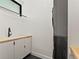 Well-lit laundry room with modern appliances and ample counter space at 2025 Fenton St, Edgewater, CO 80214
