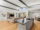 Bright living room with sleek kitchen island, hardwood floors, and modern beam ceiling at 2025 Fenton St, Edgewater, CO 80214