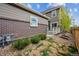 Backyard view with low maintenance landscaping, a private deck, and a view of the exterior of the home at 3831 E 141St Ave, Thornton, CO 80602