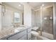 Modern bathroom with granite countertops, gray cabinetry, glass enclosed shower and contemporary fixtures at 3831 E 141St Ave, Thornton, CO 80602