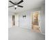 Bedroom featuring neutral paint, carpet, a ceiling fan and an ensuite bathroom with glass enclosed shower at 3831 E 141St Ave, Thornton, CO 80602