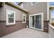 Back deck, showing brick and paneled exterior, large sliding door to interior, with a neutral railing at 3831 E 141St Ave, Thornton, CO 80602