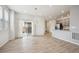 Open dining area with hardwood floors, stylish chandelier, and sliding glass doors to the backyard at 3831 E 141St Ave, Thornton, CO 80602
