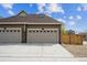 Three car garage, showing driveway and partial side yard, brick and paneled exterior, and neutral coloring at 3831 E 141St Ave, Thornton, CO 80602