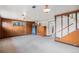 Spacious basement area with carpet, wood paneling, and staircase at 1010 Kennedy Dr, Westminster, CO 80234