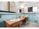 Bathroom with double vanity, tile walls, and a large mirror at 1010 Kennedy Dr, Westminster, CO 80234