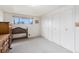 Bright bedroom with large closet, neutral carpeting, and wood furniture at 1010 Kennedy Dr, Westminster, CO 80234