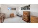Bedroom featuring natural light from two windows, neutral carpet, and wood furniture at 1010 Kennedy Dr, Westminster, CO 80234