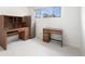 Bright bedroom features two desks, a filing cabinet, and a window for natural light at 1010 Kennedy Dr, Westminster, CO 80234