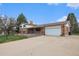 Inviting home with a two-car garage, brick facade, and a well-maintained driveway at 1010 Kennedy Dr, Westminster, CO 80234