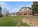 Two-story home with brick and white siding, offering a backyard view and ample lawn space at 1010 Kennedy Dr, Westminster, CO 80234