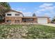 Charming brick home with an attached garage and manicured front lawn at 1010 Kennedy Dr, Westminster, CO 80234