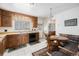 Traditional kitchen with wood cabinets, white tile floors, and a cozy breakfast nook at 1010 Kennedy Dr, Westminster, CO 80234