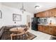 Eat-in kitchen featuring plaid accents, black appliances and adjacent staircase at 1010 Kennedy Dr, Westminster, CO 80234