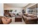 Cozy living room featuring comfortable seating and a large window with security bars at 1010 Kennedy Dr, Westminster, CO 80234