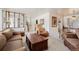 Bright living room with staircase, classic furniture, and view to the kitchen area at 1010 Kennedy Dr, Westminster, CO 80234