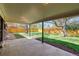 Spacious covered patio overlooking a fenced backyard with a lush green lawn and mature trees, perfect for entertaining at 1669 S Kearney St, Denver, CO 80224