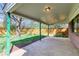 Covered patio overlooking a well-maintained backyard with green lawn, mature trees, and a wooden privacy fence at 1669 S Kearney St, Denver, CO 80224