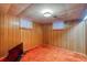 Cozy finished basement with classic wood paneling and retro carpeting, creating a warm and inviting space at 1669 S Kearney St, Denver, CO 80224