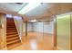 Finished basement with ample space, bright lighting, and stairs, perfect for recreation or storage at 1669 S Kearney St, Denver, CO 80224