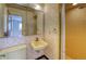 Retro bathroom with yellow fixtures, classic wallpaper, and a walk-in shower, exuding vintage charm at 1669 S Kearney St, Denver, CO 80224