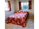 Cozy bedroom featuring a floral bedspread, windows, and neutral carpet, creating a comfortable and inviting personal space at 1669 S Kearney St, Denver, CO 80224