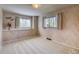 Bright bedroom with patterned wallpaper, neutral carpeting, and dual windows with natural light at 1669 S Kearney St, Denver, CO 80224