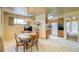 Cozy dining area adjacent to the kitchen, featuring a chandelier and a wooden dining set at 1669 S Kearney St, Denver, CO 80224