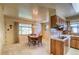 Dining area with a chandelier, wooden table, and direct access to the retro-styled kitchen at 1669 S Kearney St, Denver, CO 80224