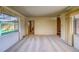Spacious living room with neutral carpeting, large windows, and a view into other parts of the home at 1669 S Kearney St, Denver, CO 80224