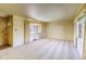Bright living room featuring neutral carpet, large windows with curtains, and a view of the front yard at 1669 S Kearney St, Denver, CO 80224