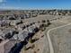 A high-angle aerial shot shows rooftops, roads, and a walking path in a suburban community on a clear day at 6722 S Winnipeg Cir # 102, Aurora, CO 80016