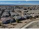 Expansive aerial view of a residential community showcasing rooftops, streets, and mountain views in the background at 6722 S Winnipeg Cir # 102, Aurora, CO 80016