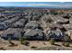 Expansive aerial view of a residential community showcasing rooftops, streets, and mountain views in the background at 6722 S Winnipeg Cir # 102, Aurora, CO 80016