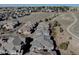 A high-angle aerial shot shows rooftops, roads, and a walking path in a suburban community on a clear day at 6722 S Winnipeg Cir # 102, Aurora, CO 80016
