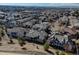 Expansive aerial view of a residential community showcasing rooftops, streets, and mountain views in the background at 6722 S Winnipeg Cir # 102, Aurora, CO 80016