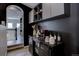 Stylish coffee bar with dark wood cabinet and floating shelves, perfect for entertaining at 6722 S Winnipeg Cir # 102, Aurora, CO 80016