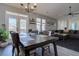 Bright dining area with modern lighting, outdoor access, and view of living area at 6722 S Winnipeg Cir # 102, Aurora, CO 80016